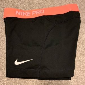 Black and orange Nike Pro spandex shorts